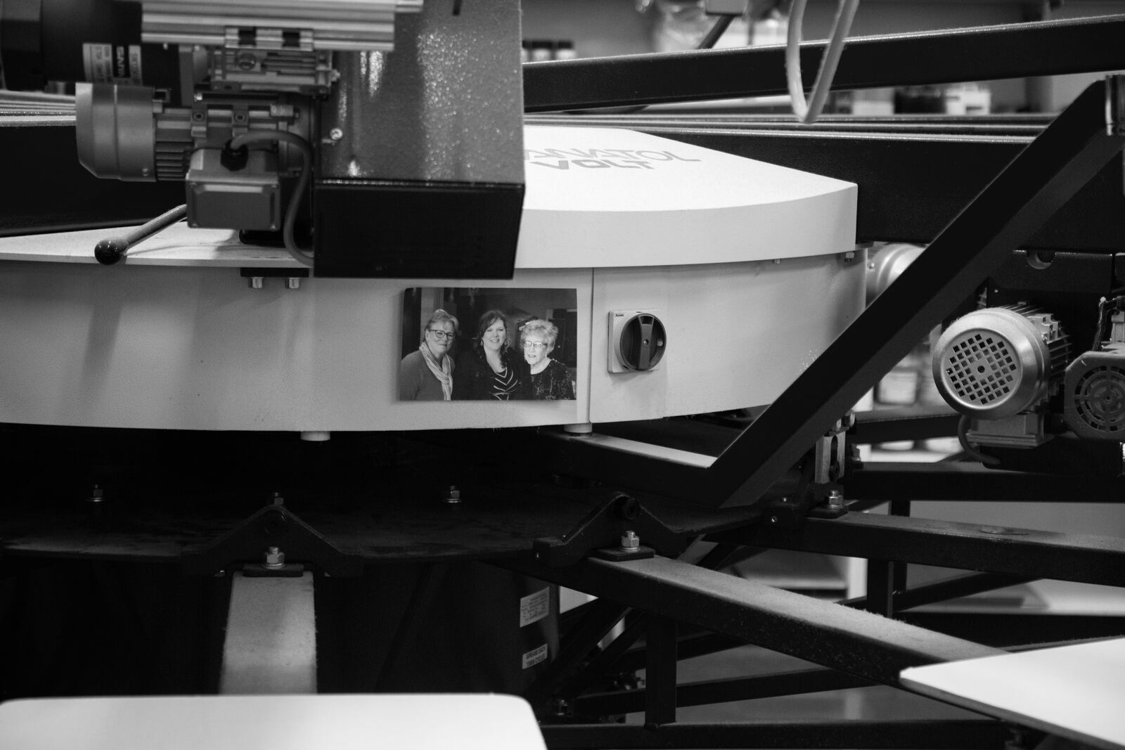 A family photo taped to the press at P&M Apparel